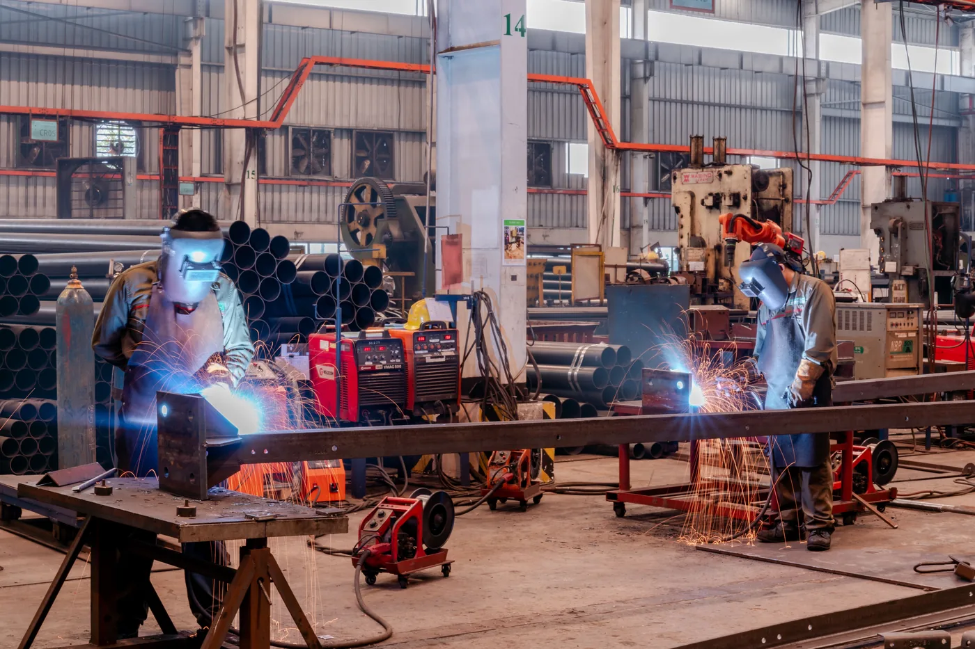 Industrial fabrication professionals working in a workshop