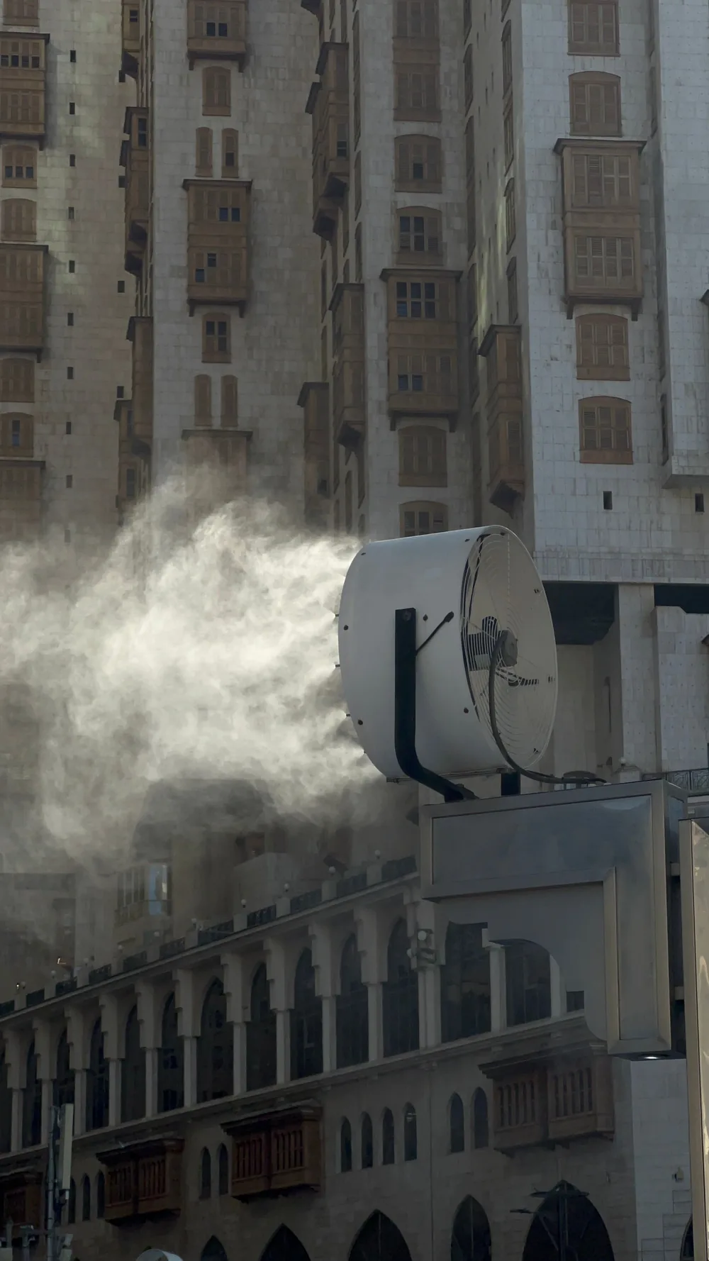 Large industrial cooling fan producing mist