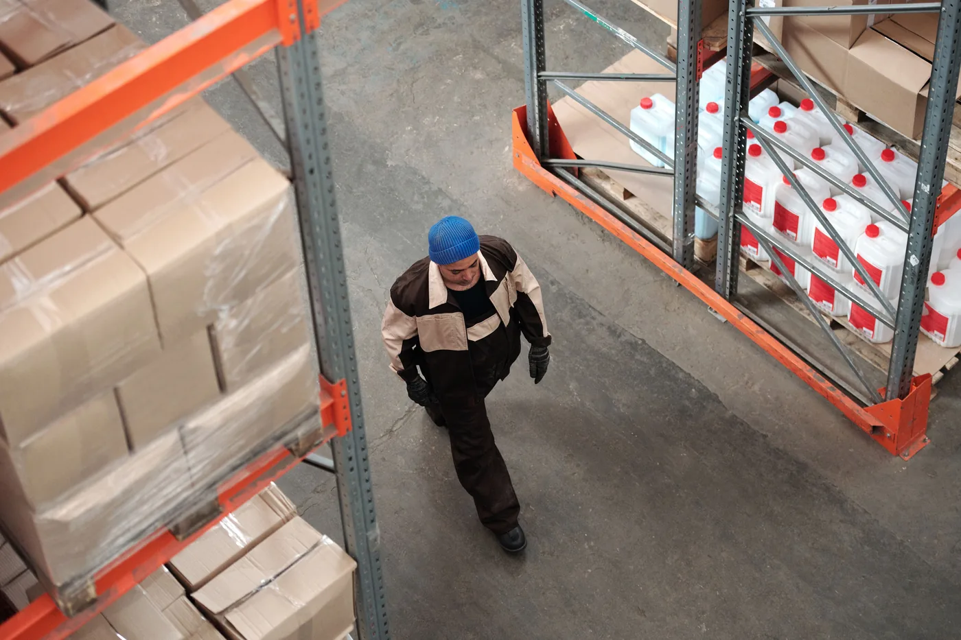 Worker walking through a large warehouse